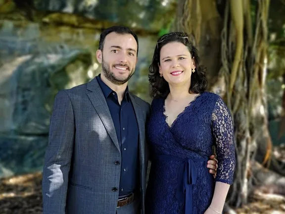 Bruno and Helô Moulin in a Sydney garden, a fig tree behind them